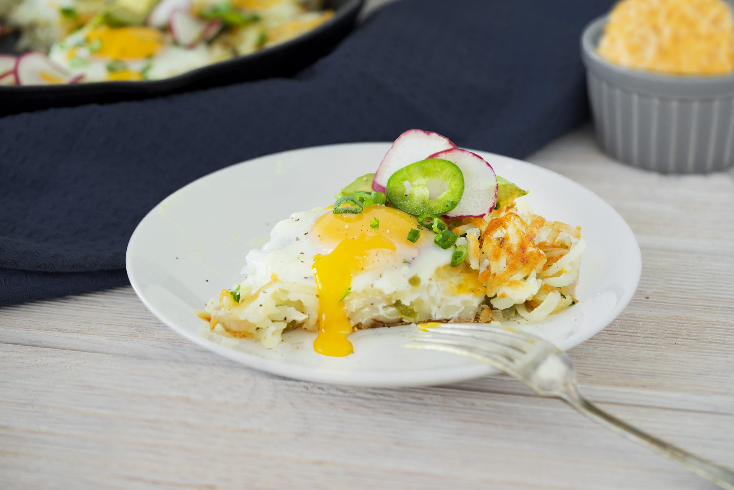 slice of hash brown skillet casserole with runny egg