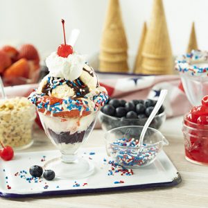 A 4th of July themed sundae in a cup with all the toppings