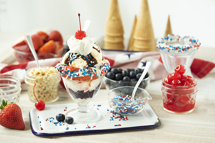 A 4th of July themed sundae in a cup with all the toppings