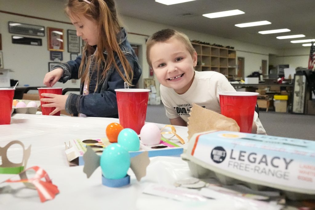 Boy smiles at community egg event
