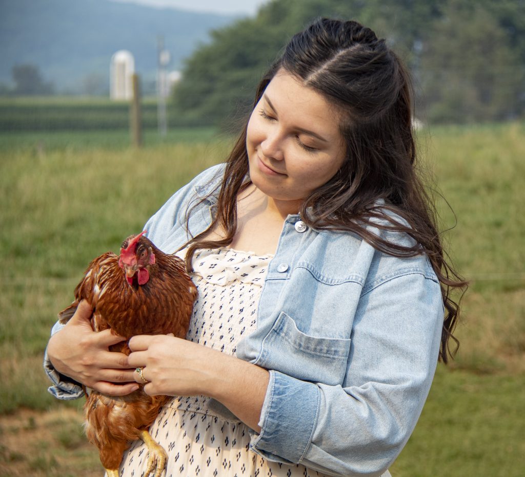 Nature's Yoke Legacy Kristen Holding Free-Range Hen